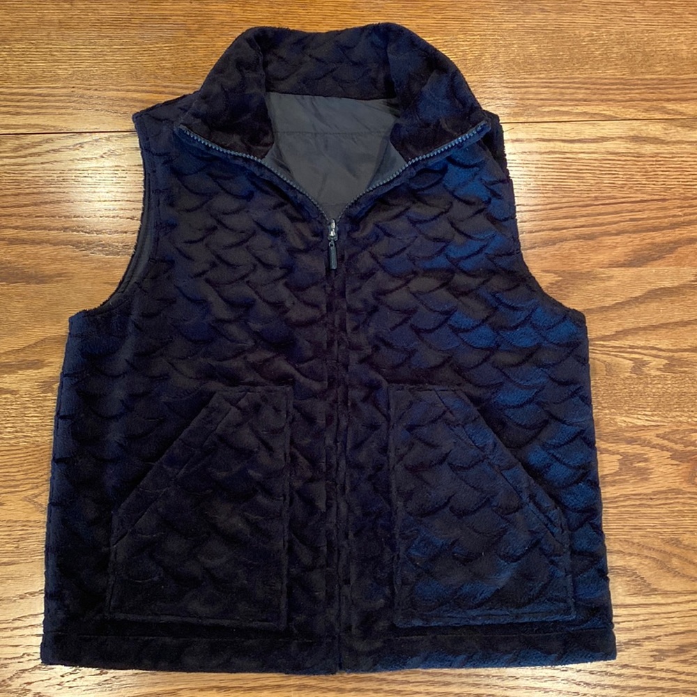Reversible Black faux fur and nylon vest.